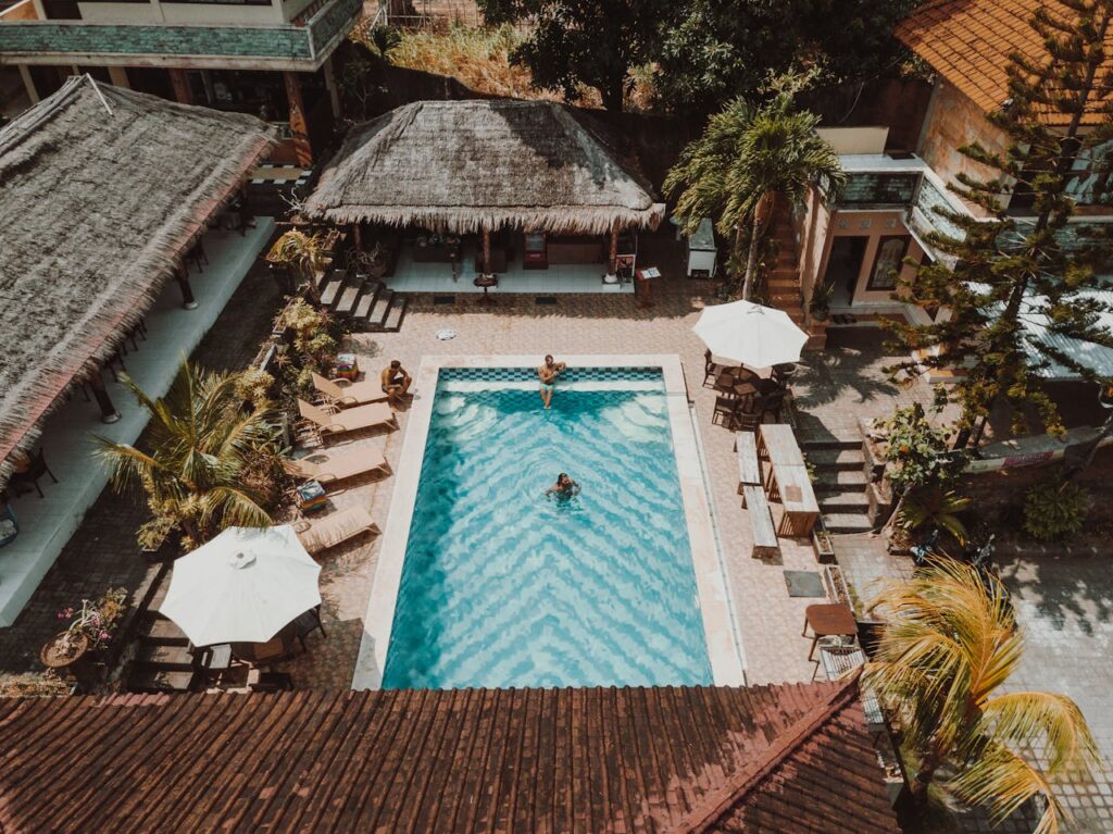 Aerial Photography of Three People in a Swimming Pool